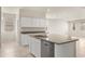 Bright kitchen featuring an island, stainless steel appliances, granite countertops, and white cabinets at 5824 E Axle Ln, San Tan Valley, AZ 85140