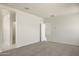 Bright, carpeted living room with neutral walls and multiple entryways allowing for great flow and versatility at 5824 E Axle Ln, San Tan Valley, AZ 85140