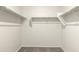 Spacious walk-in closet with neutral walls and carpet, featuring plentiful shelving for optimal organization at 5824 E Axle Ln, San Tan Valley, AZ 85140