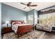 Cozy bedroom with natural light, hardwood floors, ceiling fan and desert landscape art at 6094 E Evening Glow Dr, Scottsdale, AZ 85266