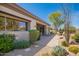 Exterior view with beautiful desert landscaping, including mature trees, cacti, and flowering plants at 6094 E Evening Glow Dr, Scottsdale, AZ 85266