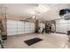 Spacious three car garage with ample space, storage racks, and epoxy flooring providing an ideal storage and parking solution at 6094 E Evening Glow Dr, Scottsdale, AZ 85266