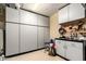 Well-organized garage featuring custom cabinetry and pegboards, maximizing storage and functionality for a clutter-free space at 6094 E Evening Glow Dr, Scottsdale, AZ 85266