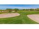 Expansive green golf course with sand traps and mature trees on a sunny day at 6094 E Evening Glow Dr, Scottsdale, AZ 85266