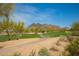 Picturesque view of the golf course, showcasing lush greens and stunning mountain scenery in the distance at 6094 E Evening Glow Dr, Scottsdale, AZ 85266