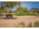 Scenic view of the golf course with mature trees, well-maintained greens, and mountain views in the background at 6094 E Evening Glow Dr, Scottsdale, AZ 85266