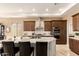Modern kitchen island boasts a marble countertop with a breakfast bar and stainless steel appliances at 6094 E Evening Glow Dr, Scottsdale, AZ 85266