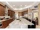 Well-equipped kitchen island with bar stool seating boasts stainless steel appliances and custom cabinetry at 6094 E Evening Glow Dr, Scottsdale, AZ 85266