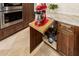 Kitchen with custom pull out mixer shelf in wood cabinetry, with marble countertop at 6094 E Evening Glow Dr, Scottsdale, AZ 85266
