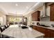Expansive island with marble countertops overlooks the breakfast nook and provides ample seating at 6094 E Evening Glow Dr, Scottsdale, AZ 85266