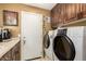 Functional laundry room with modern washer and dryer, storage cabinets, and countertops for efficient organization and convenience at 6094 E Evening Glow Dr, Scottsdale, AZ 85266
