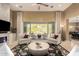Living room featuring a stone fireplace with backyard views and neutral decor at 6094 E Evening Glow Dr, Scottsdale, AZ 85266