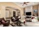 Open concept living room with a decorative fireplace and a view of the front entry at 6094 E Evening Glow Dr, Scottsdale, AZ 85266