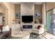 Light and bright living room space showcasing fireplace with stone surround and backyard views at 6094 E Evening Glow Dr, Scottsdale, AZ 85266