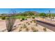 Beautifully landscaped outdoor area featuring a built-in fireplace and views of the golf course and mountain at 6094 E Evening Glow Dr, Scottsdale, AZ 85266
