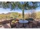 Covered patio with mountain views, table and comfortable seating for four at 6094 E Evening Glow Dr, Scottsdale, AZ 85266