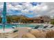Inviting community pool offers pristine water, lounge chairs, dining tables, and desert mountain views at 6094 E Evening Glow Dr, Scottsdale, AZ 85266