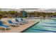 The community pool area features plentiful lounge seating, umbrellas, mountain views, and pristine landscaping at 6094 E Evening Glow Dr, Scottsdale, AZ 85266