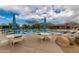 Community pool featuring outdoor tables, chairs, umbrellas, and mountain views for residents enjoyment at 6094 E Evening Glow Dr, Scottsdale, AZ 85266