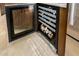 Modern wine refrigerator built into kitchen cabinetry, showcasing storage for wine bottles at 6094 E Evening Glow Dr, Scottsdale, AZ 85266