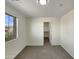 Bright bedroom boasts a large window, walk in closet and neutral decor, providing comfort and ample space at 6602 S 23Rd Ave, Phoenix, AZ 85041
