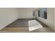 Spacious carpeted bedroom with ample natural light, complemented by fresh neutral paint and large windows at 6602 S 23Rd Ave, Phoenix, AZ 85041
