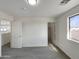 Inviting bedroom features carpeted floors, ample natural light, and a view to the hall and closet at 6602 S 23Rd Ave, Phoenix, AZ 85041