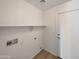Efficient laundry room with laminate flooring, open shelving, utility hookups, and a crisp, clean design at 6602 S 23Rd Ave, Phoenix, AZ 85041