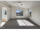 Spacious main bedroom features plush carpet, ample sunlight, and a serene atmosphere for relaxation at 6602 S 23Rd Ave, Phoenix, AZ 85041
