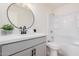 Contemporary bathroom with a round mirror and a sleek vanity, plus a shower-tub combo at 6823 W Coolidge St, Phoenix, AZ 85033