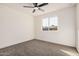 Well-lit bedroom featuring a window and neutral carpet flooring, creating a cozy atmosphere at 6823 W Coolidge St, Phoenix, AZ 85033