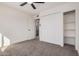 Clean bedroom with carpet and built-in storage shelves offer style and functionality at 6823 W Coolidge St, Phoenix, AZ 85033