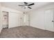 Bedroom featuring built-in shelves, closet space, and neutral carpeting at 6823 W Coolidge St, Phoenix, AZ 85033