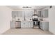Modern kitchen with stainless steel appliances, light gray cabinets, and white countertops at 6823 W Coolidge St, Phoenix, AZ 85033