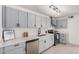 Modern kitchen with stainless steel appliances, light gray cabinets, and white countertops at 6823 W Coolidge St, Phoenix, AZ 85033