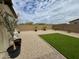 Low-maintenance backyard featuring desert landscaping, artificial turf, and a cozy seating area at 905 S 108Th Ave, Avondale, AZ 85323