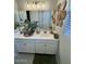 Well-decorated bathroom featuring a large mirror, white cabinets, and modern fixtures at 905 S 108Th Ave, Avondale, AZ 85323