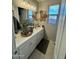 Stylish bathroom featuring a marble countertop, white cabinets, and decorative wall art at 905 S 108Th Ave, Avondale, AZ 85323