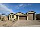 Charming single-story home featuring a brick driveway, neutral stucco, and a two-car garage at 905 S 108Th Ave, Avondale, AZ 85323