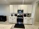 White kitchen featuring stainless steel appliances and modern countertops at 905 S 108Th Ave, Avondale, AZ 85323