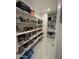 Well-organized walk-in pantry features ample shelving for optimal storage at 905 S 108Th Ave, Avondale, AZ 85323