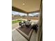 Cozy covered patio with outdoor furniture, a grill, and a view of the landscaped backyard at 905 S 108Th Ave, Avondale, AZ 85323