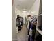 Walk-in closet with plenty of hanging space and storage for shoes and accessories at 905 S 108Th Ave, Avondale, AZ 85323