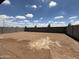 Large backyard with dirt and block fence at 9543 W Parkway Dr, Tolleson, AZ 85353