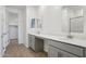 Bright bathroom featuring double sinks, bright counters, and a view into the closet at 9543 W Parkway Dr, Tolleson, AZ 85353