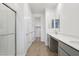Bathroom includes double sinks, a glass enclosed shower, and a view into the closet at 9543 W Parkway Dr, Tolleson, AZ 85353