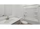 Bright bathroom features a shower and tub combo, a modern vanity, and white fixtures at 9543 W Parkway Dr, Tolleson, AZ 85353