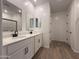 Bright bathroom with double sinks, white cabinets, and modern fixtures at 9543 W Parkway Dr, Tolleson, AZ 85353