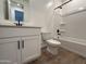 Bright bathroom featuring a tub with shower, vanity with black hardware, and wood-style tile flooring at 9543 W Parkway Dr, Tolleson, AZ 85353