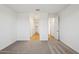 Spacious bedroom with neutral walls and plush carpeting offers views into hallway and closet at 9543 W Parkway Dr, Tolleson, AZ 85353